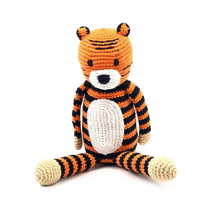 Crocheted tiger toy with orange, black, and white stripes on a white background