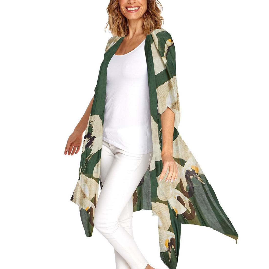 A long kimono with 3/4 length sleeves featuring a heron print in forest green, displayed on a mannequin.
