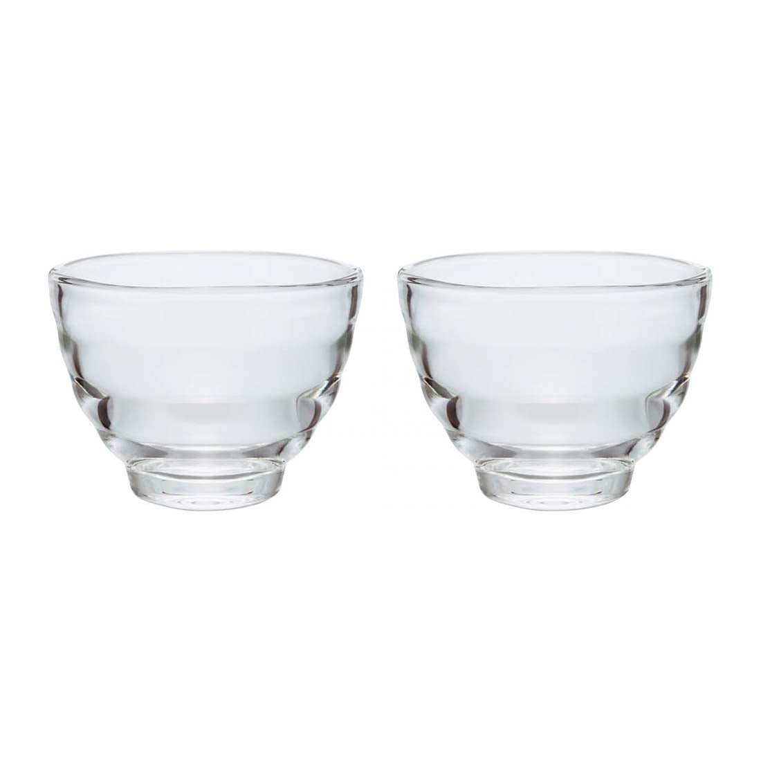 Two clear glass tea cups on a white background