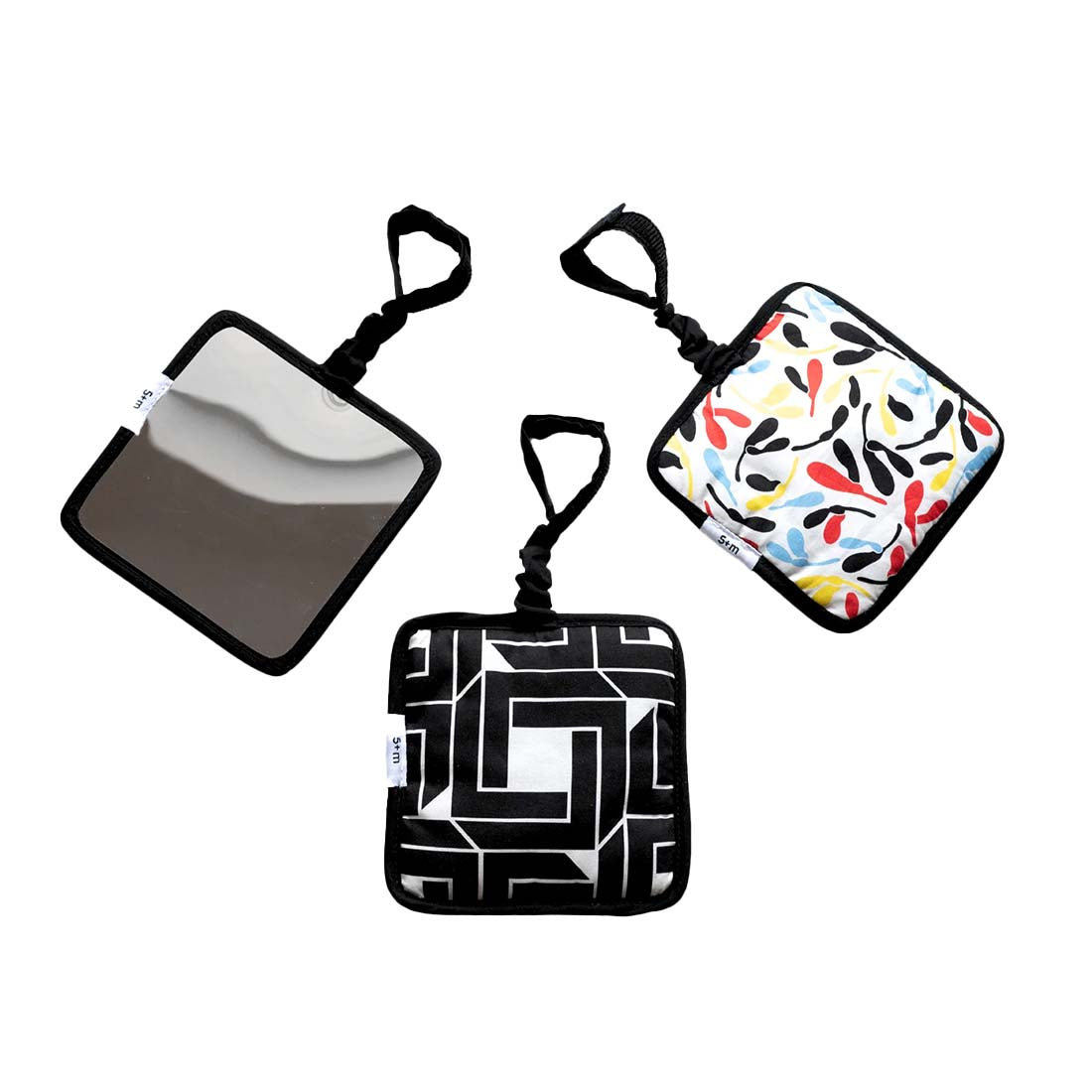 Three baby sensory hanging squares with various patterns, including a leaf design, a geometric pattern, and a mirror design, displayed against a white background.