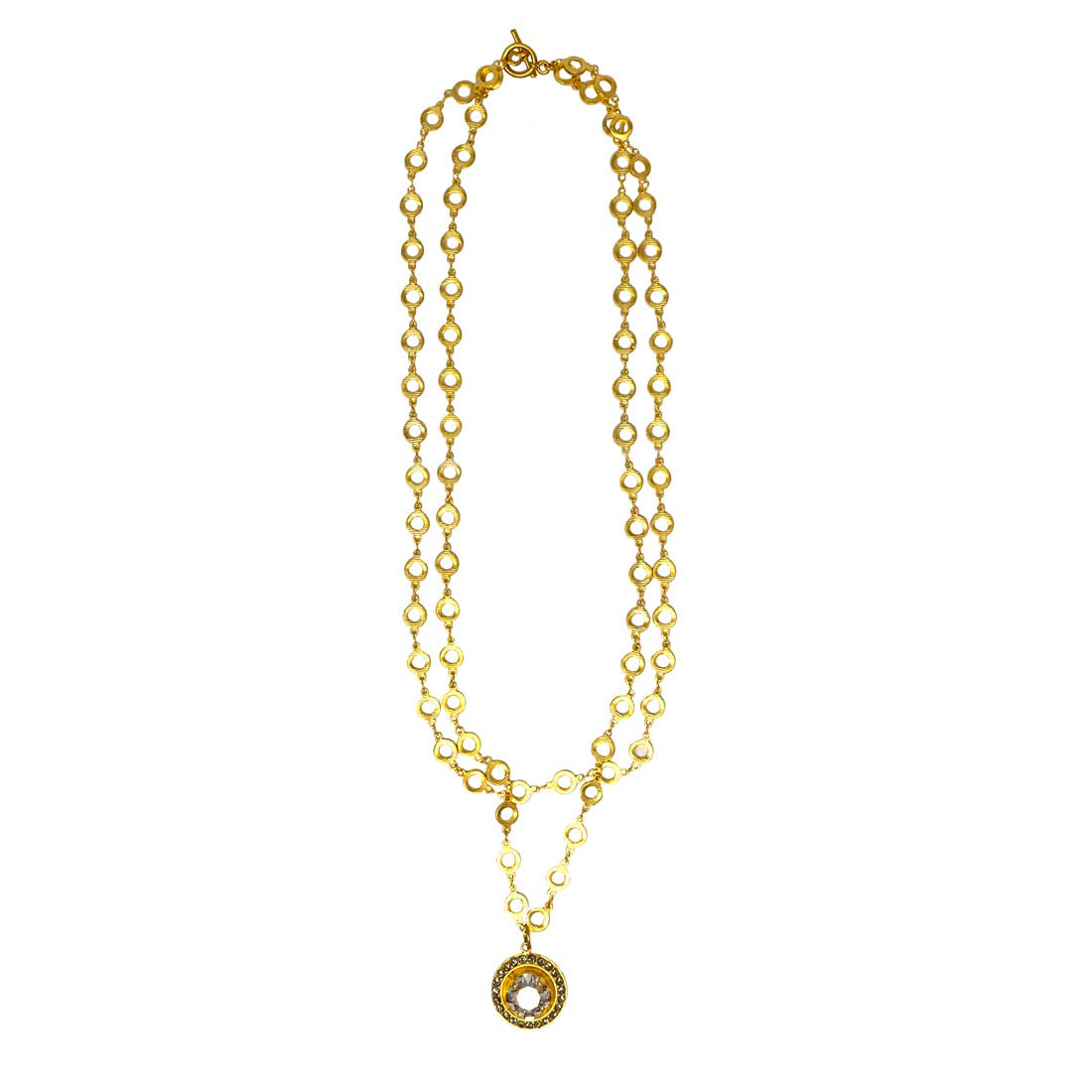 A gold-colored double-layered necklace with crystal drops and circular ornamental designs.