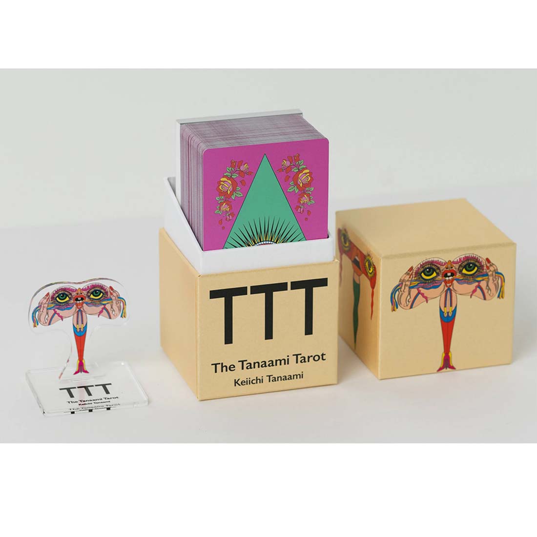 Three tarot card boxes with colorful designs on a white background