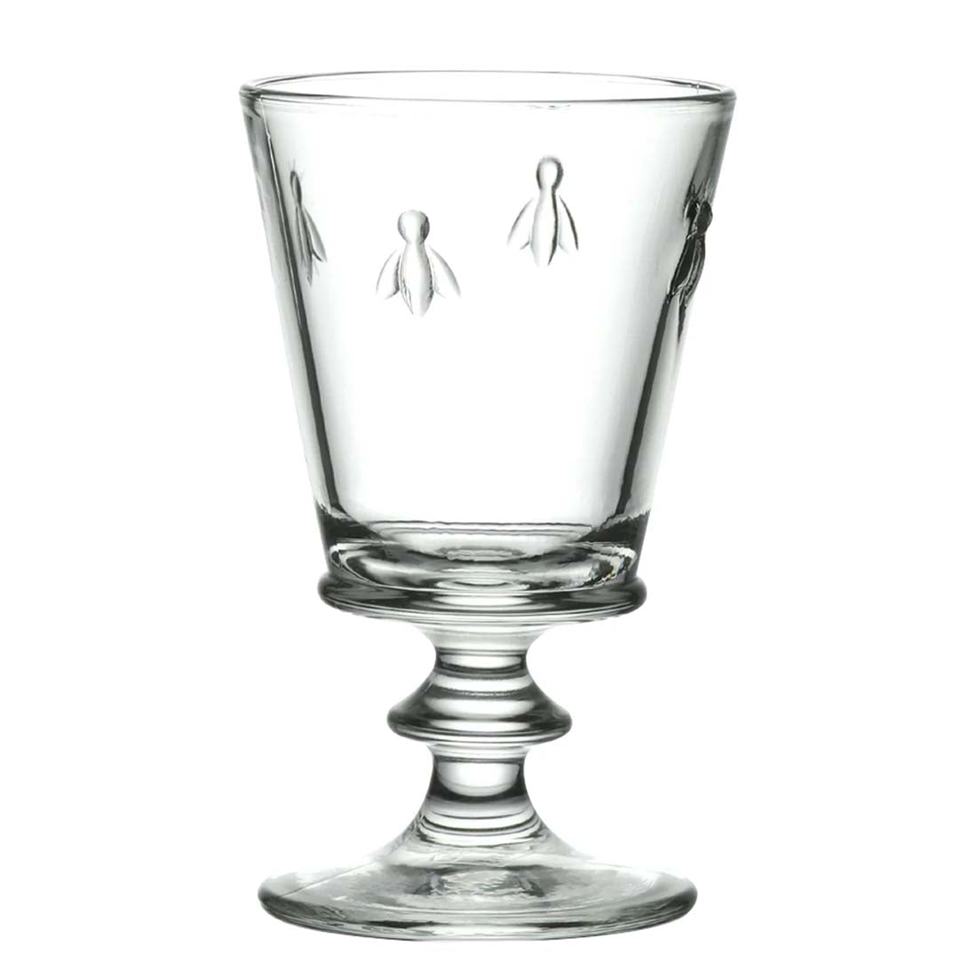 Clear glass with decorative pedestal base on a white background
