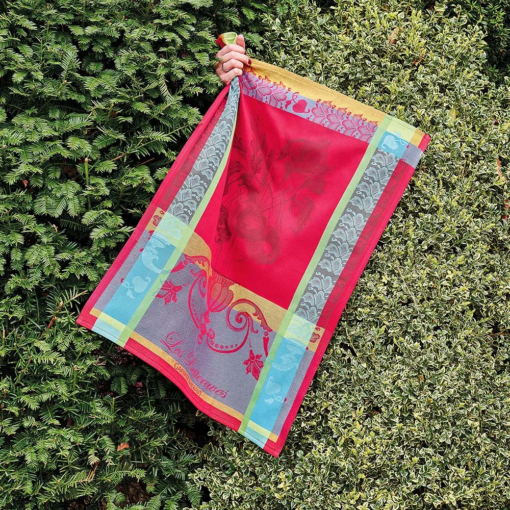 Decorative kitchen towel with colorful border and central design, featuring the brand 'Garnier Thiebaut'.
