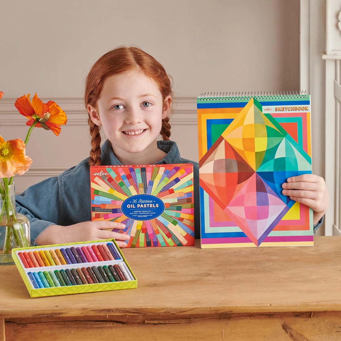 Colorful geometric-patterned sketchbook with a spiral binding on a white background