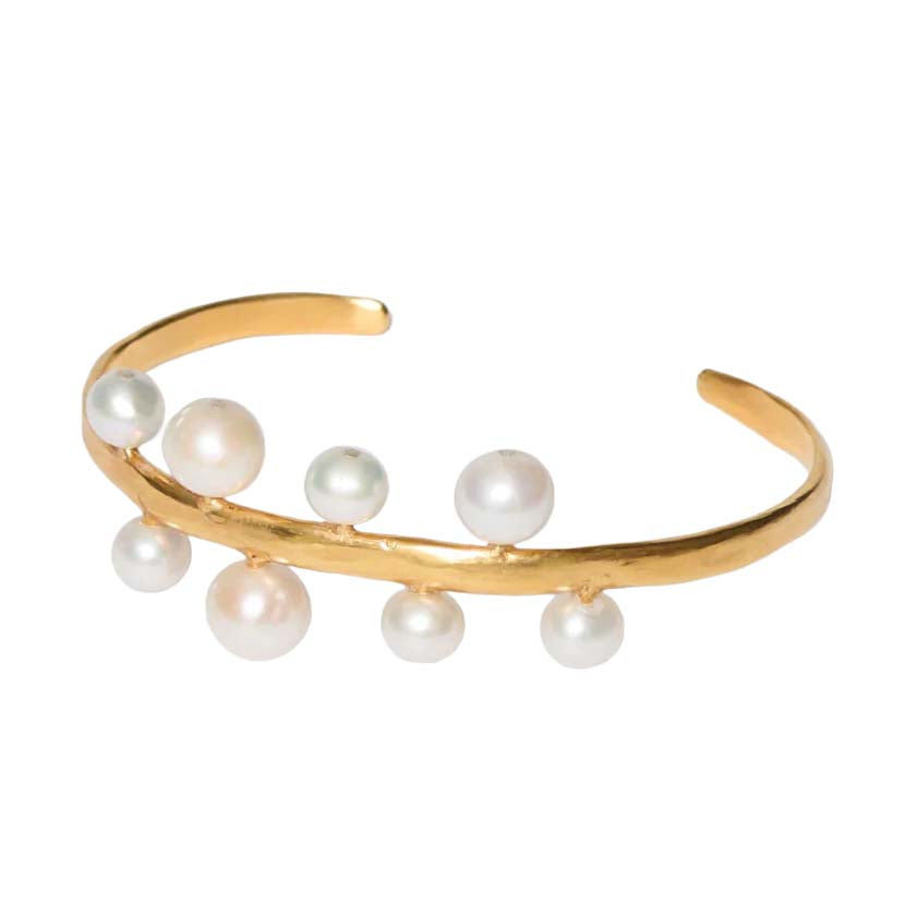 Gold bracelet with pearls on a white background