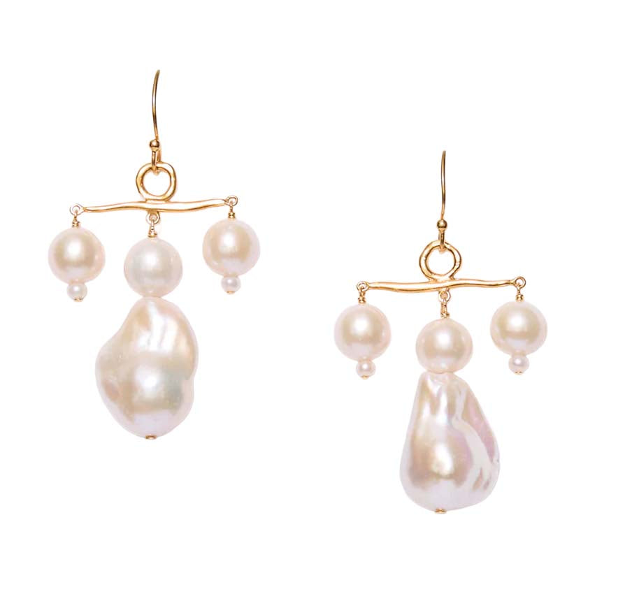 Pair of pearl earrings with gold hooks on a white background