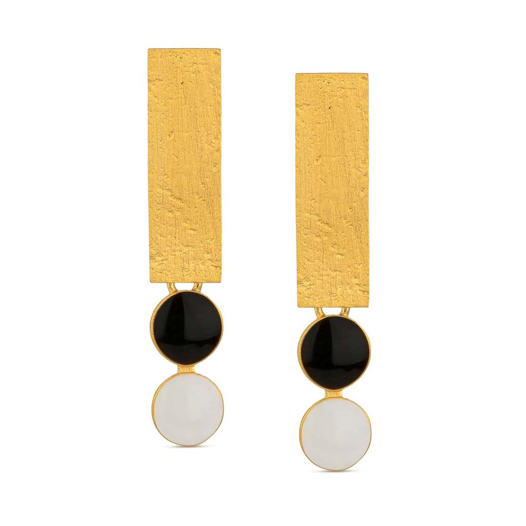 Pair of earrings with gold rectangular tops, black and white circular bottoms on a white background