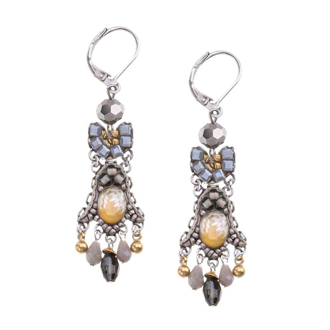 Pair of ornate earrings with beads on a white background