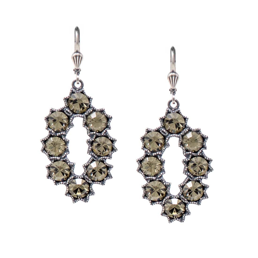 Pair of ornate earrings with smoky green gemstones on a white background