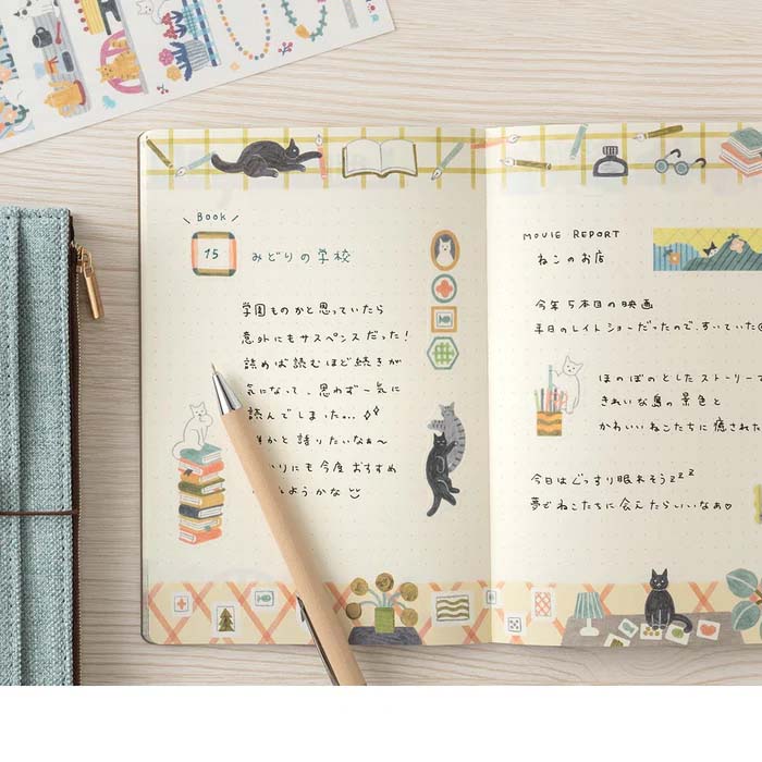 Notebook with cat illustrations on a geometric patterned cover