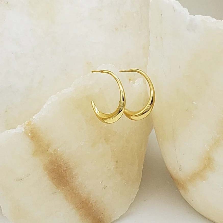 Gold hoop earrings on a white background
