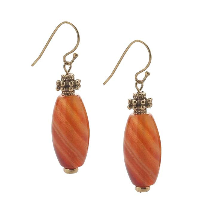 Pair of orange beaded earrings with gold accents on a white background