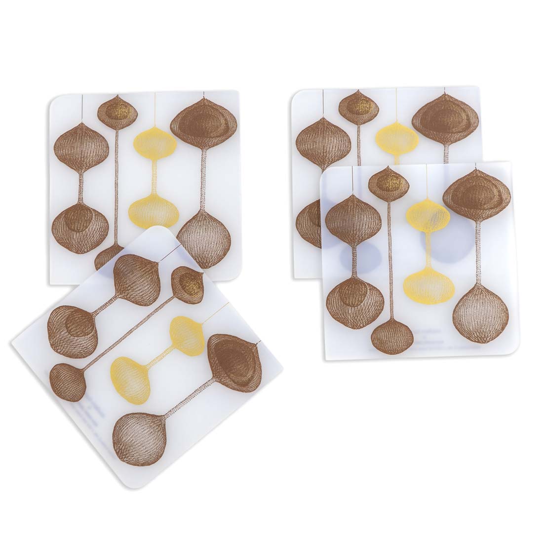 Set of four coasters with decorative design on a white background