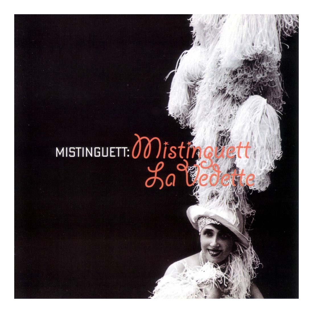 Album cover with a person wearing a decorative headpiece against a black background, featuring the text 'Mistinguett: La Vedette'.