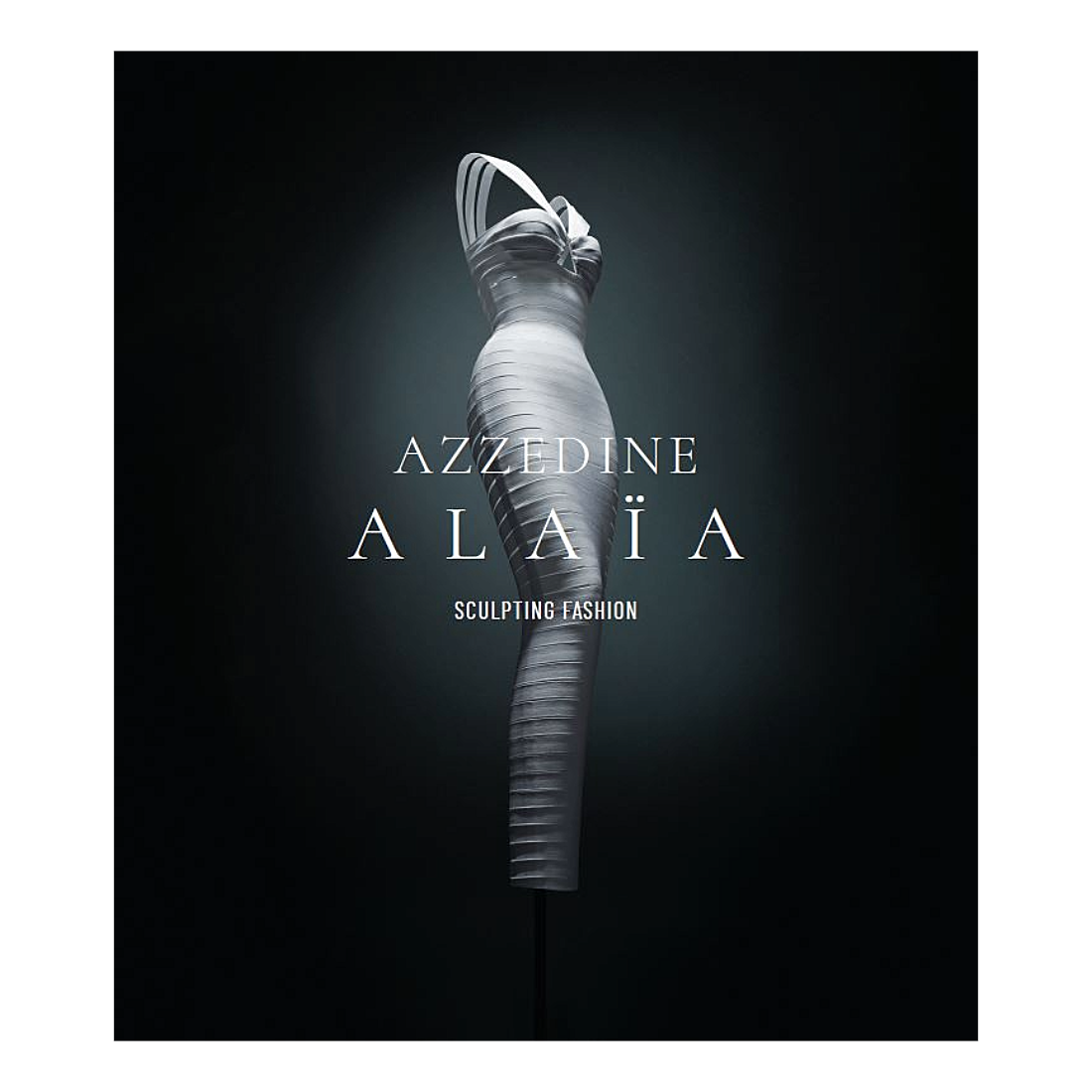 A sculptural white dress displayed on a mannequin against a dark black background, with the text 'AZZEDINE ALAÜA SCULPTING FASHION' centered on the front.