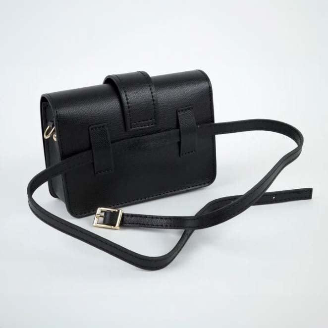 Black handbag with gold chain strap on a white background