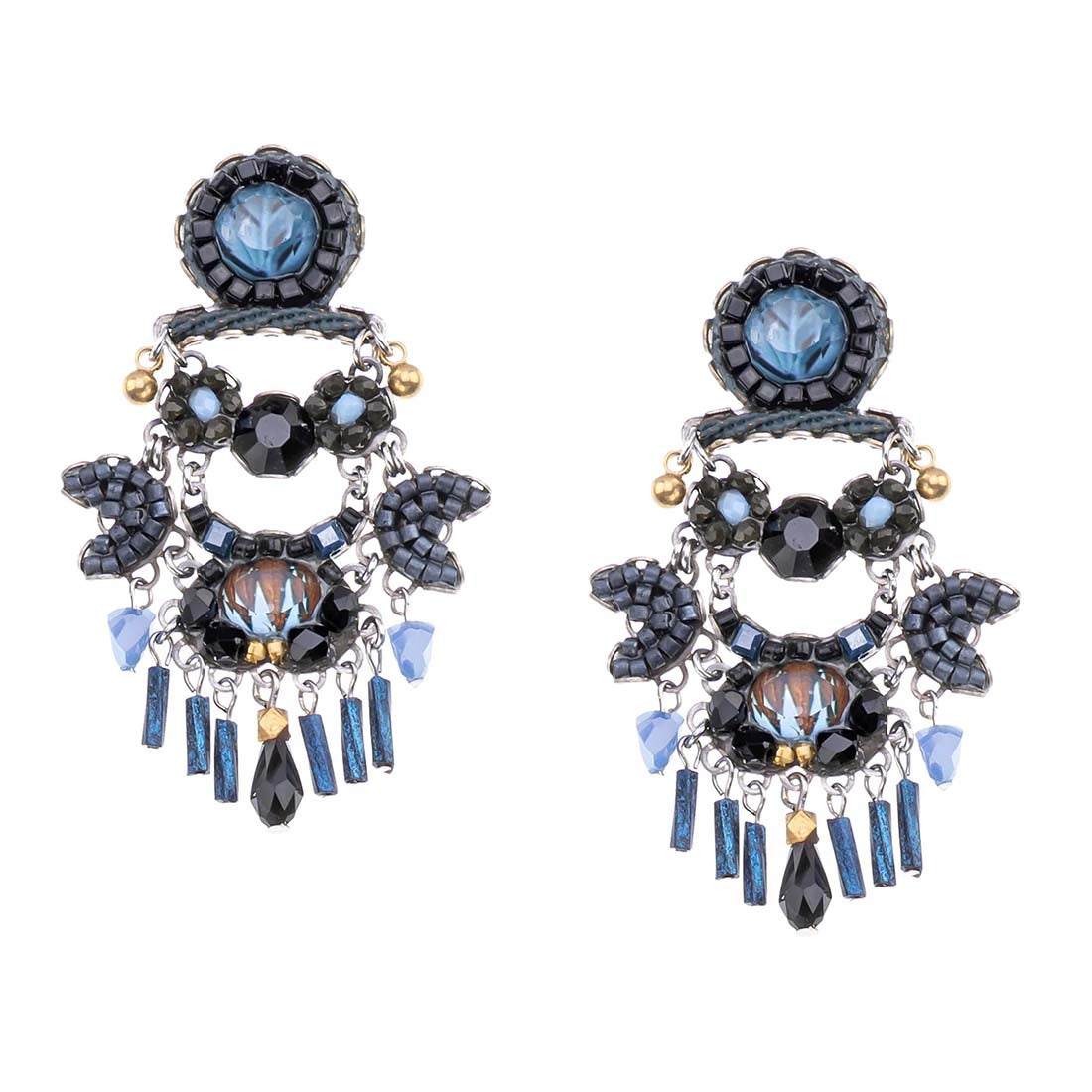 Pair of ornate earrings with blue and black gemstones on a white background