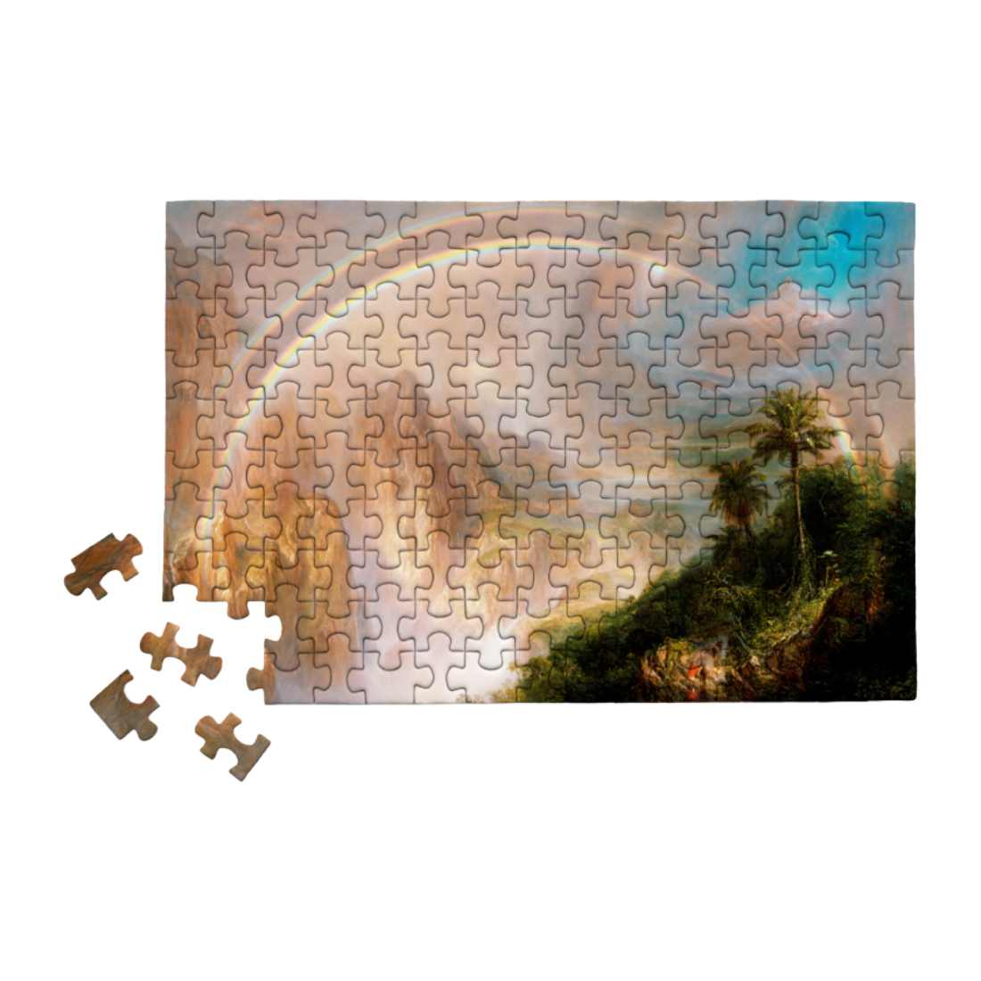 A completed rectangular jigsaw puzzle showing a scenic landscape with a rainbow arching across a cloudy sky and palm trees on a hill, displayed on a white background with four loose puzzle pieces beside it.