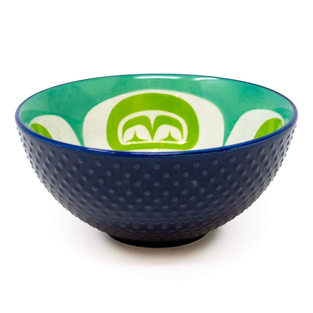 A medium-sized porcelain bowl with a contemporary Indigenous design in green and white colors, with a blue rim.