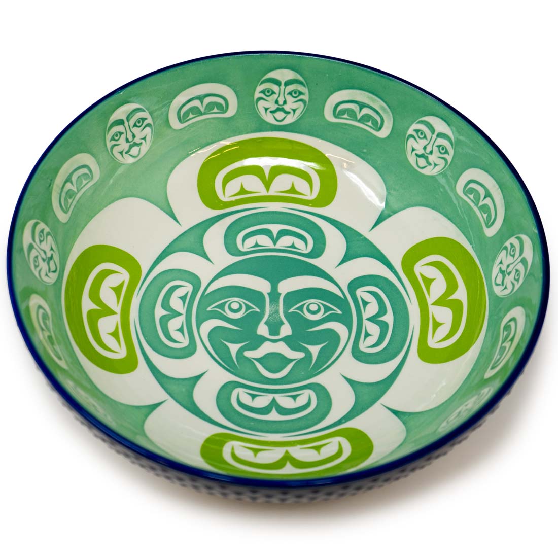 A porcelain serving bowl with a contemporary Indigenous design in green, blue, and white colors.