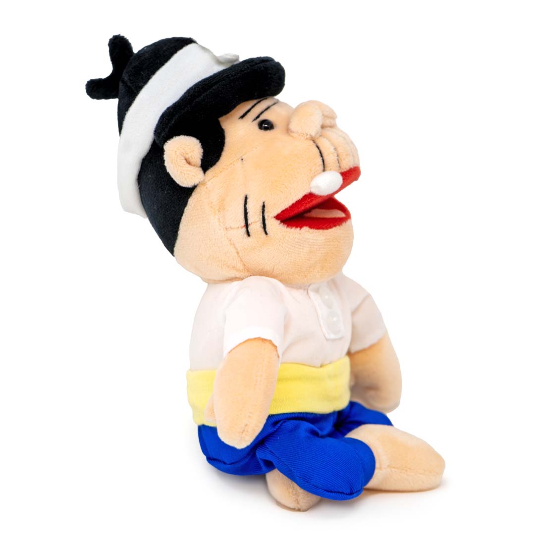 Plush toy of a character with a white shirt, blue pants, and a black and white hat on a white background