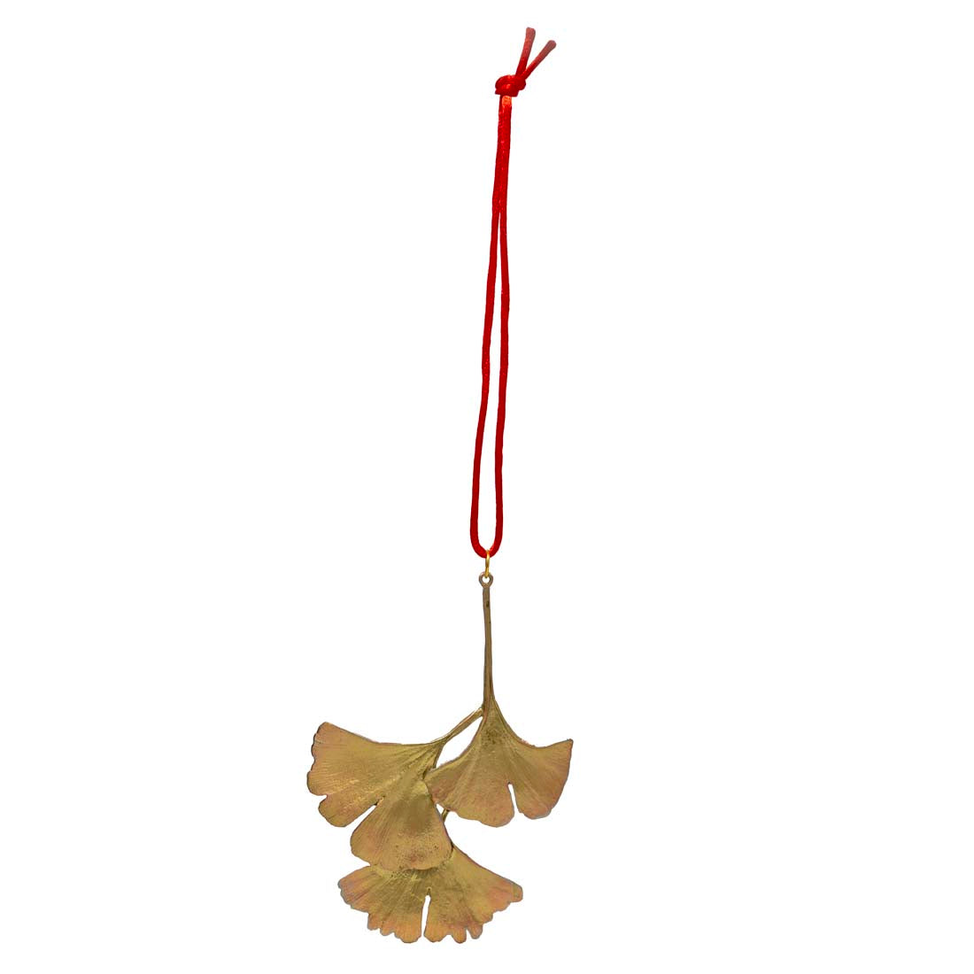 Gold ginkgo leaf ornament hanging on a red string against a white background