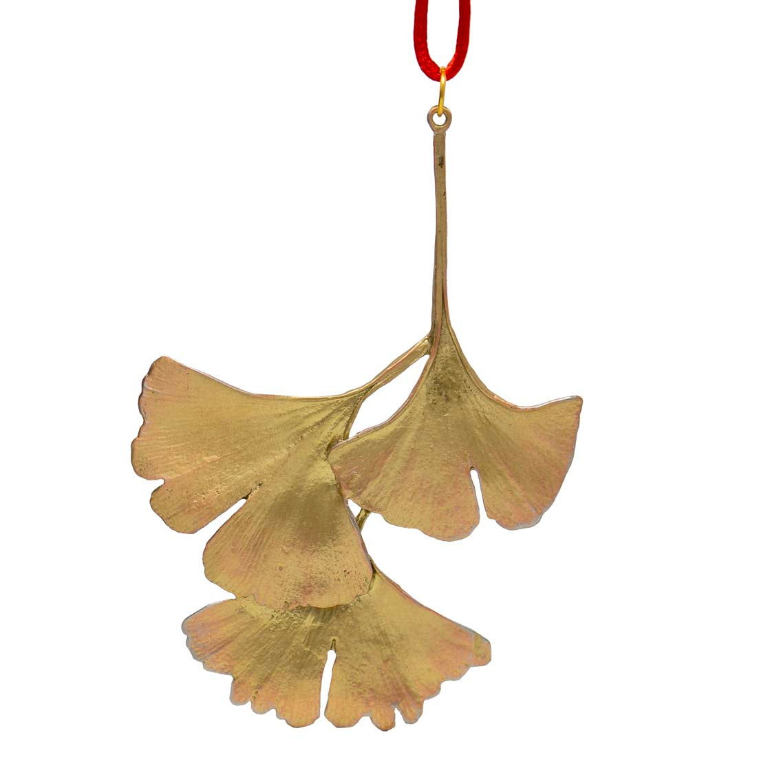 Gold ginkgo leaf ornament hanging on a red string against a white background