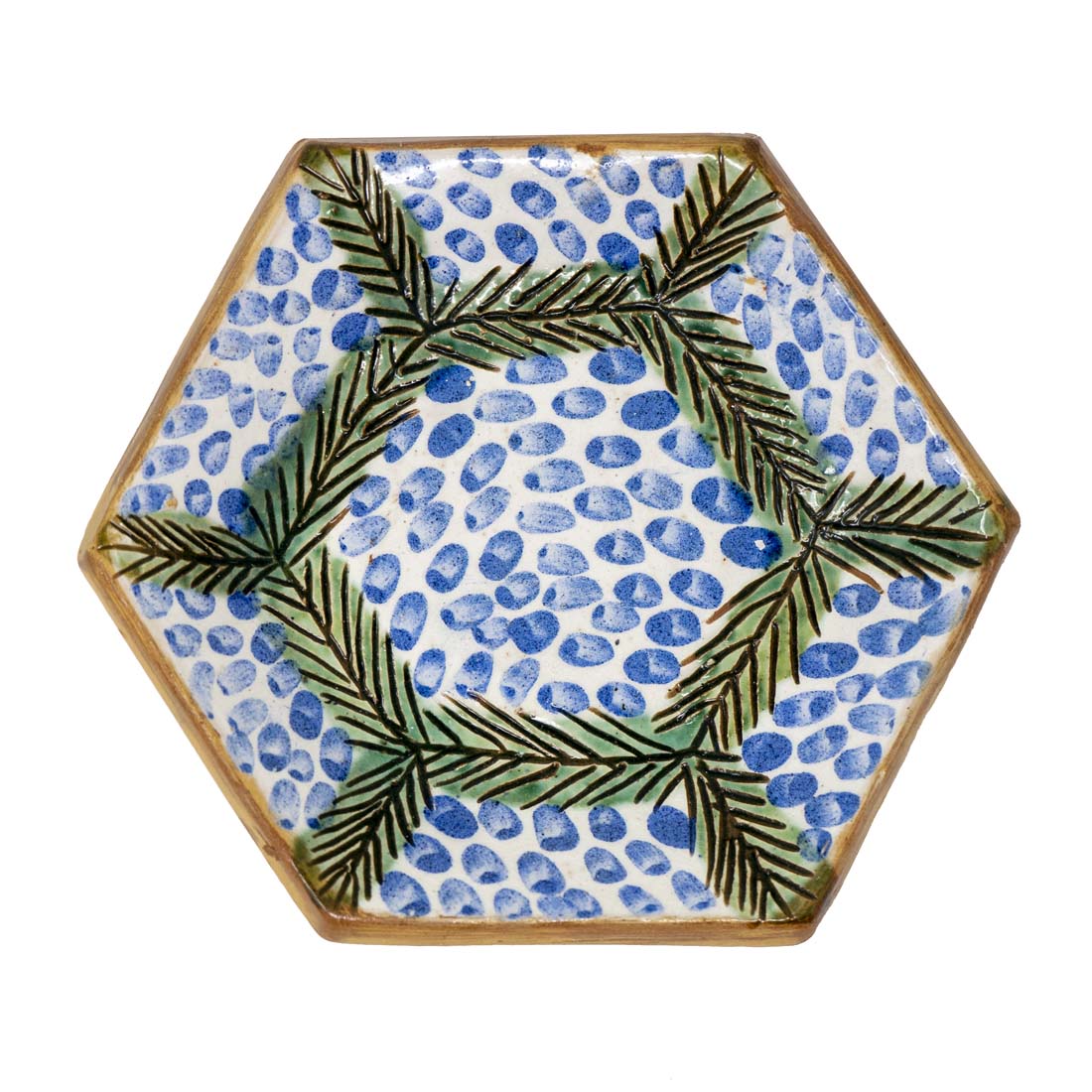 Hexagonal ceramic plate with blue and green pattern on a white background