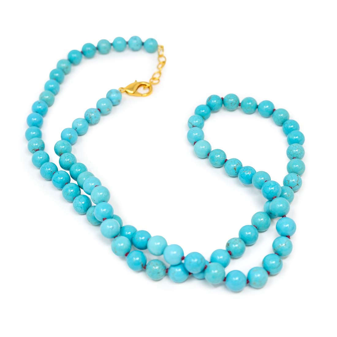 Turquoise bead necklace with a gold clasp on a white background
