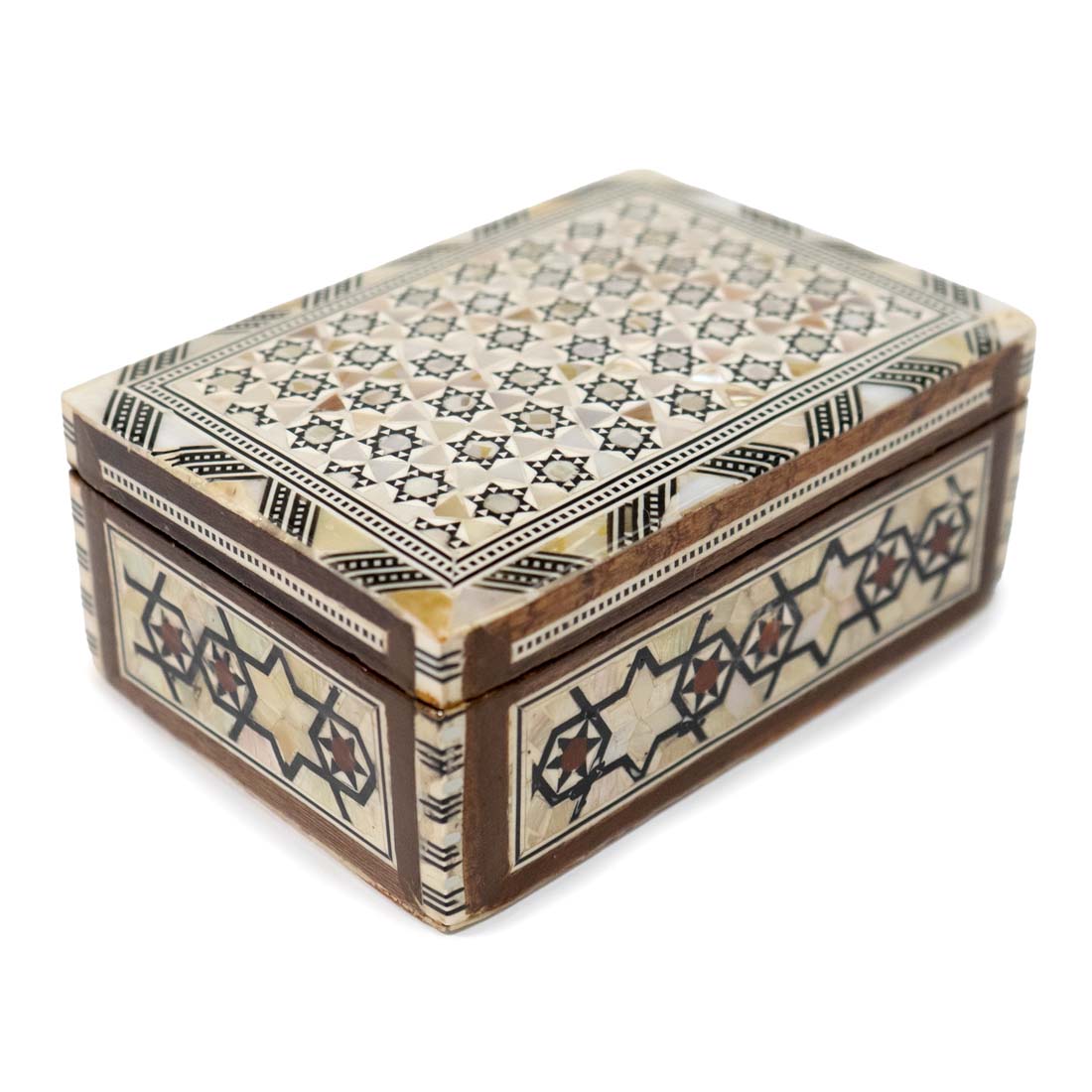 Decorative wooden box with intricate star patterns on a white background