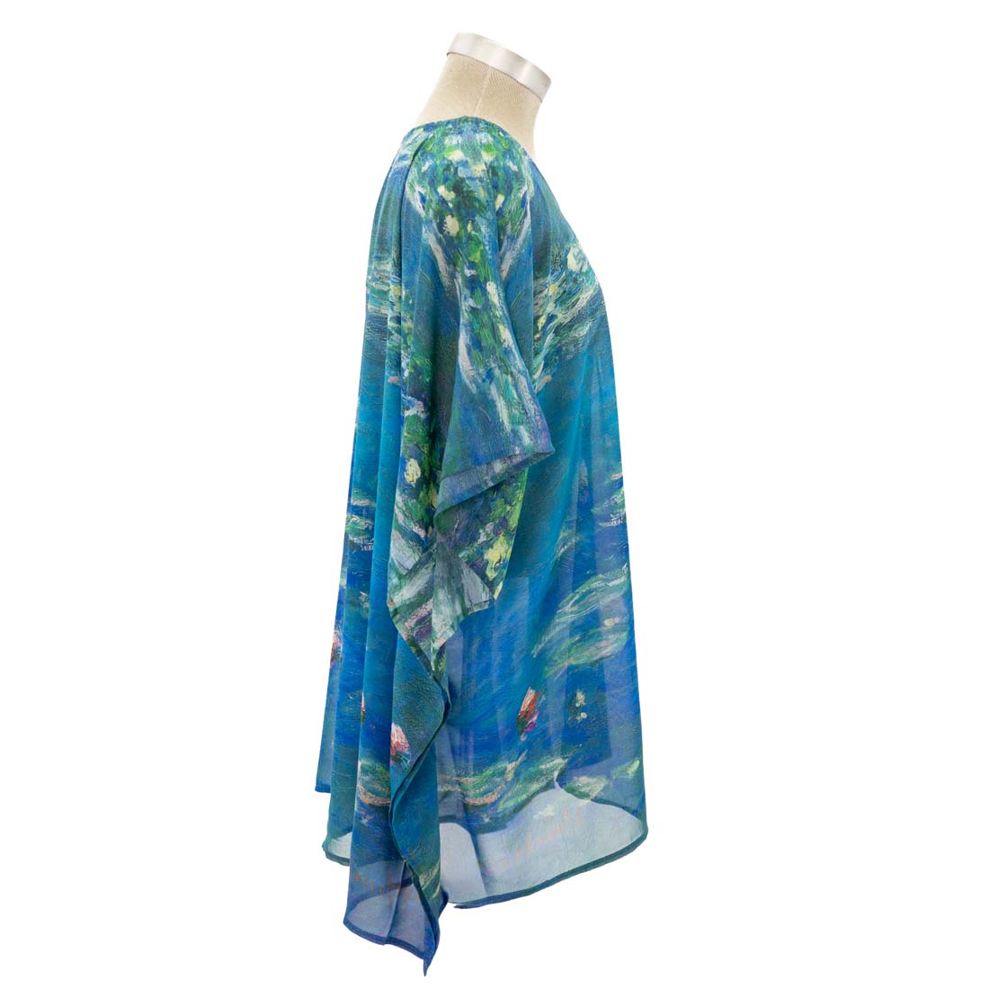 Mannequin wearing a blue and green patterned poncho on a white background