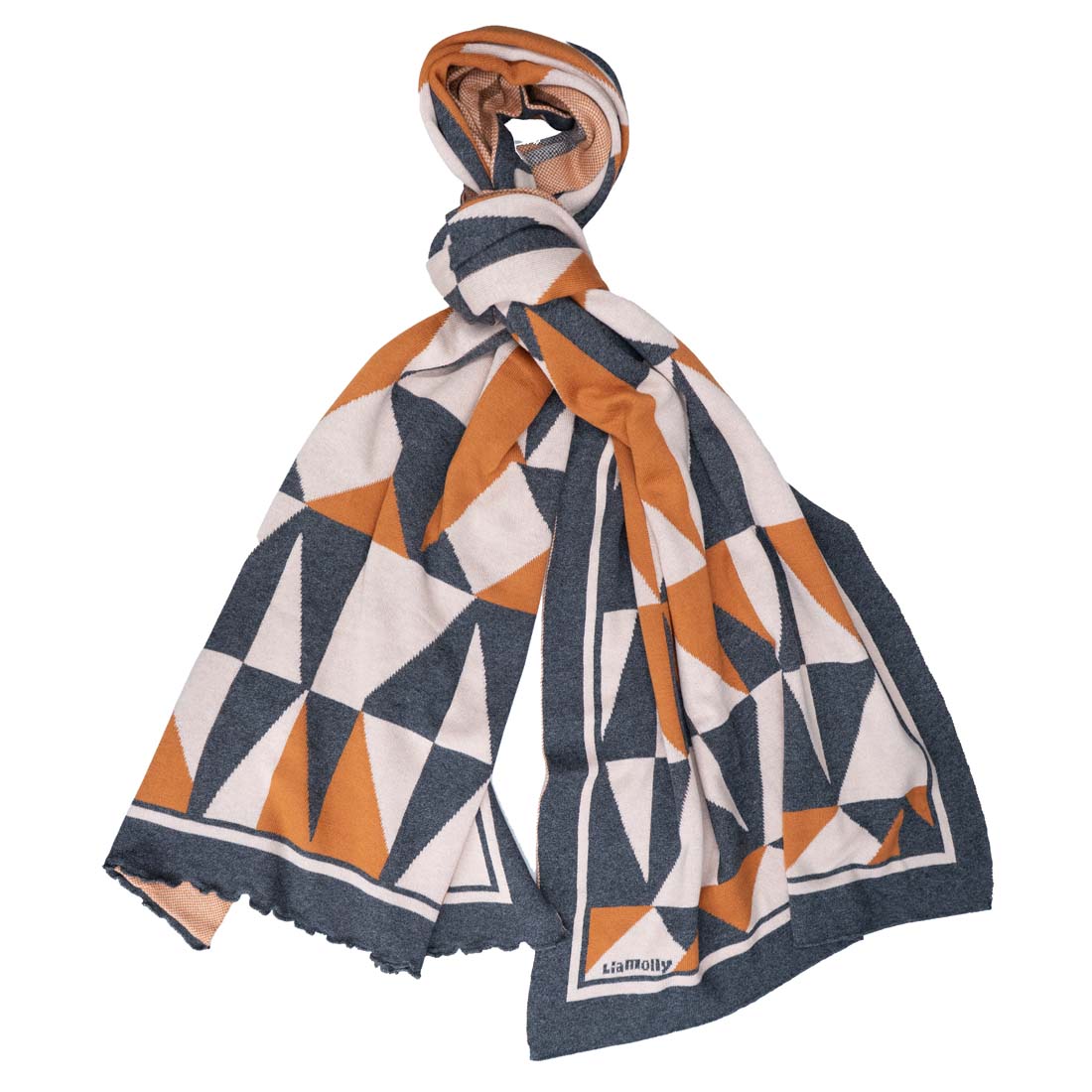 A geometric patterned wrap in cinnamon, charcoal, and white colors, draped and knotted at the ends.