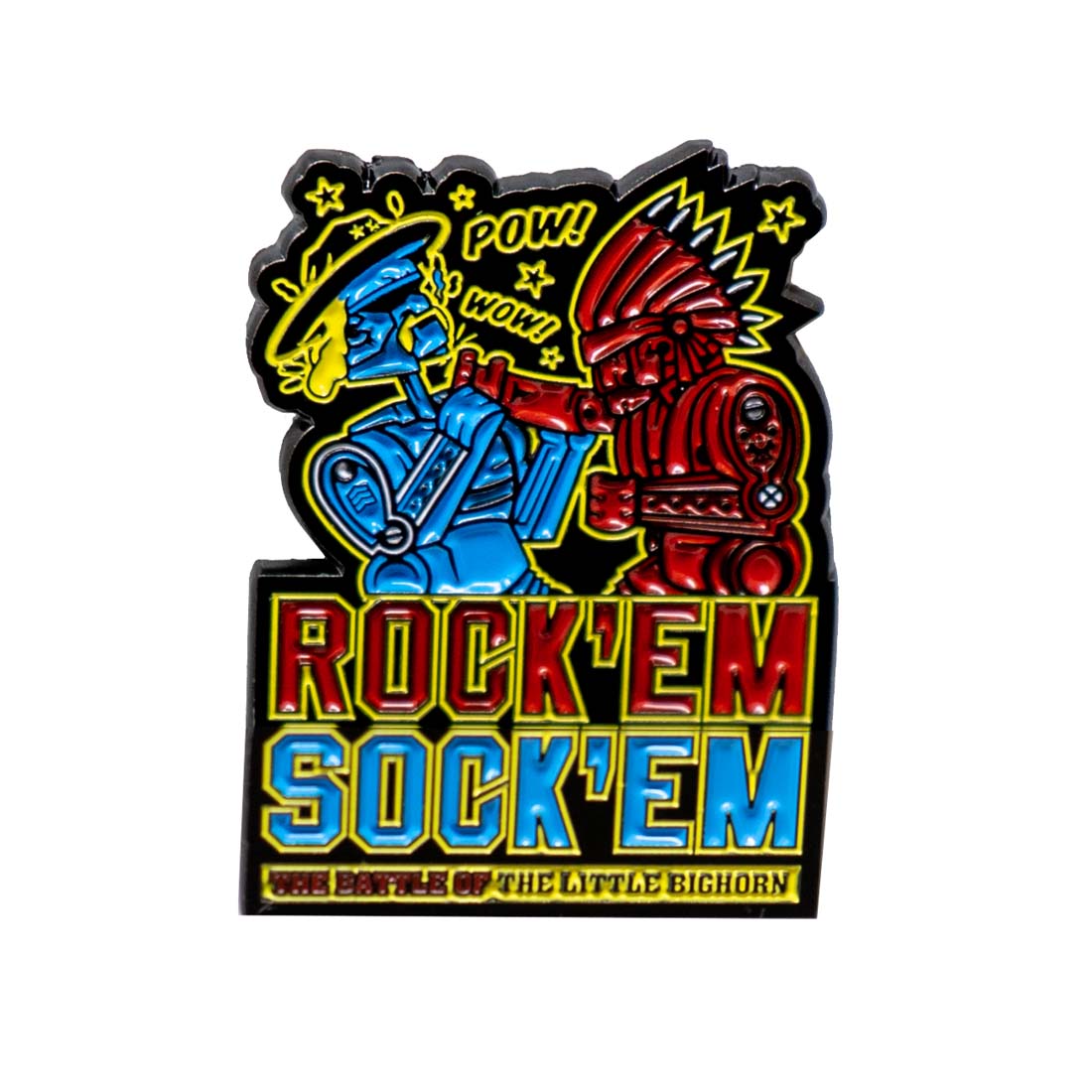 An enamel pin featuring cartoonish characters resembling Rock'em Sock'em with one wearing a cowboy hat and the other in a Native American Chief headdress, with bold text and colorful design.