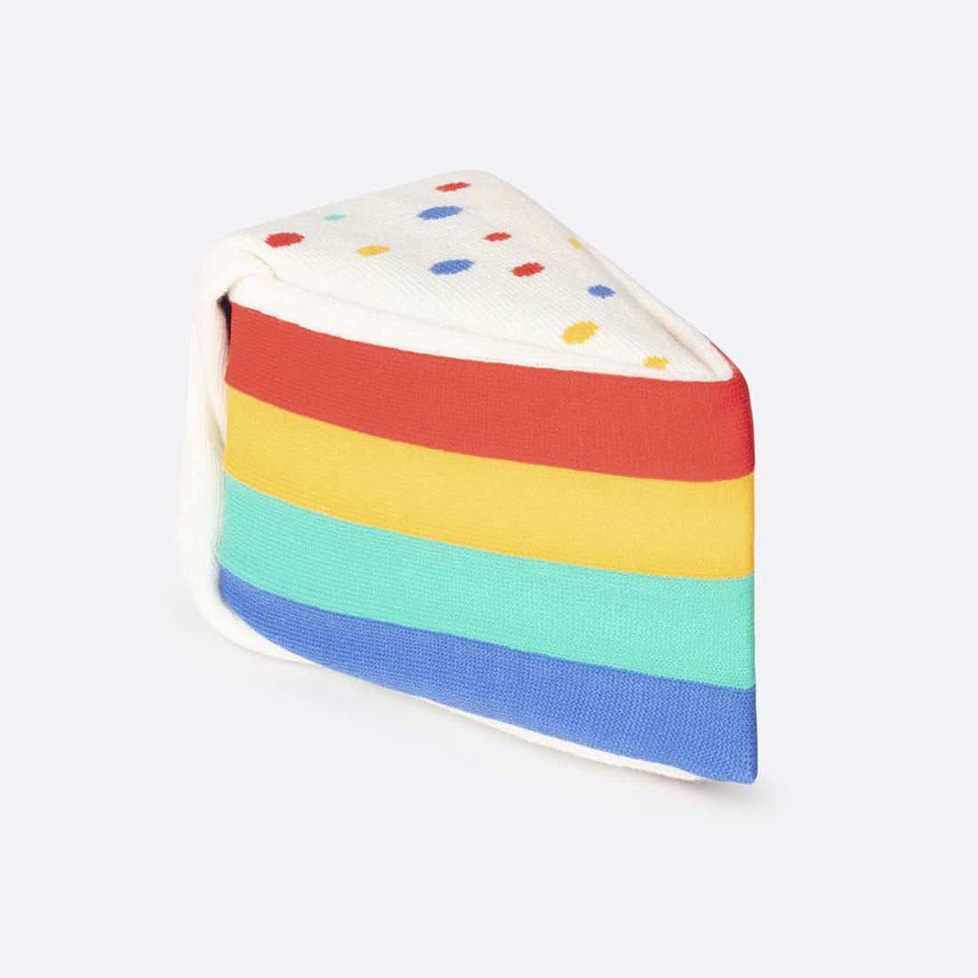 A packaged pair of over the calf socks designed to look like a rainbow cake, with various colored layers and decorative dots, in a box labeled 'Rainbow Cake Socks'.