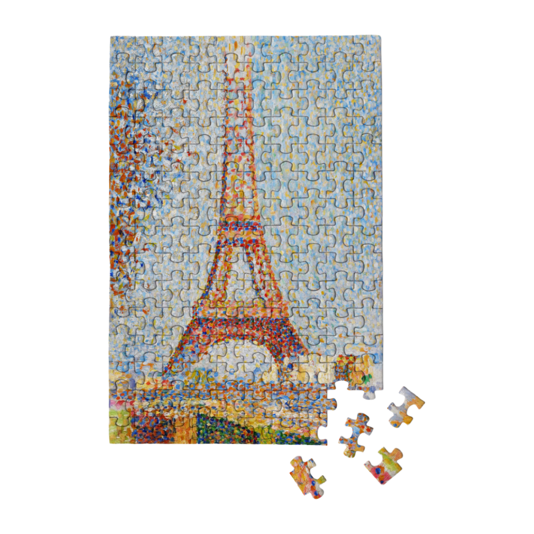 A completed jigsaw puzzle showing a colorful Eiffel Tower scene, with a few loose puzzle pieces placed in front on a plain white background.