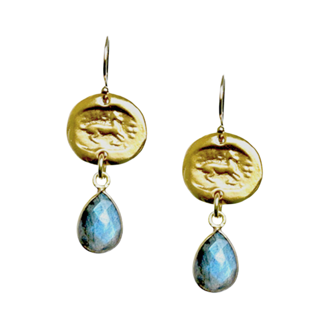 Gold earrings with blue teardrop stones on a white background
