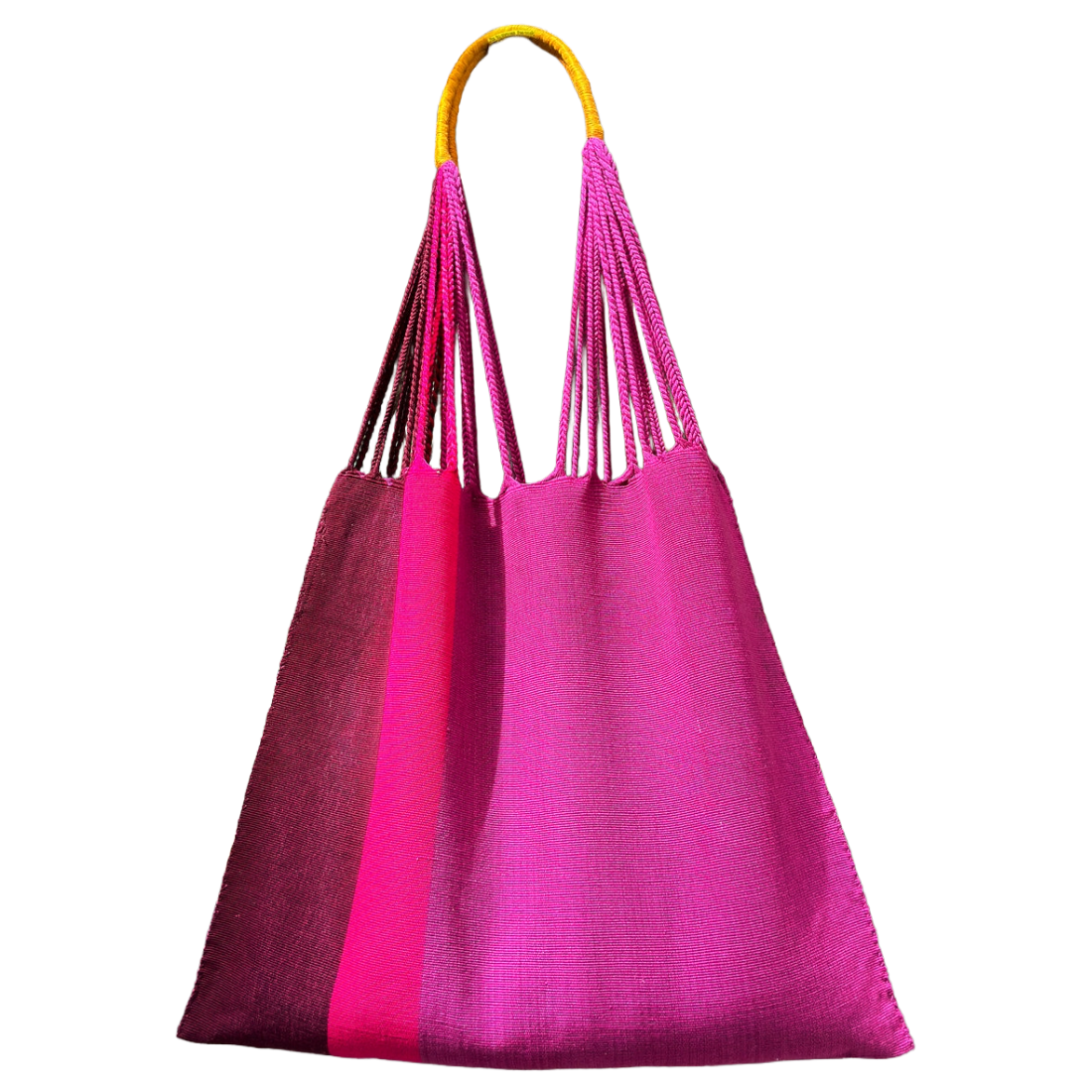 A large woven tote bag in vibrant magenta pink, featuring a bright yellow rope handle and three vertical braided shoulder straps, shown against a plain white background.