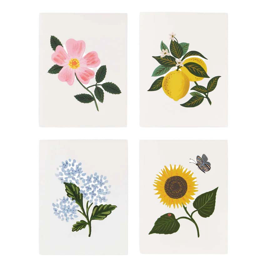Four square tiles with floral and botanical designs on a white background