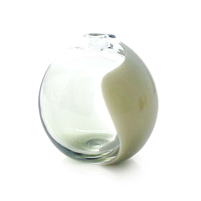 Glass vase with a white ceramic base on a white background