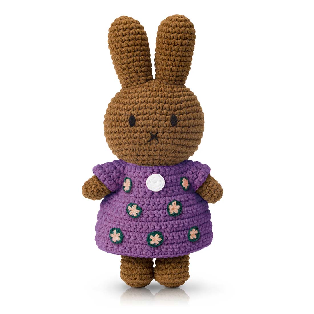Crocheted toy rabbit with a purple dress on a white background