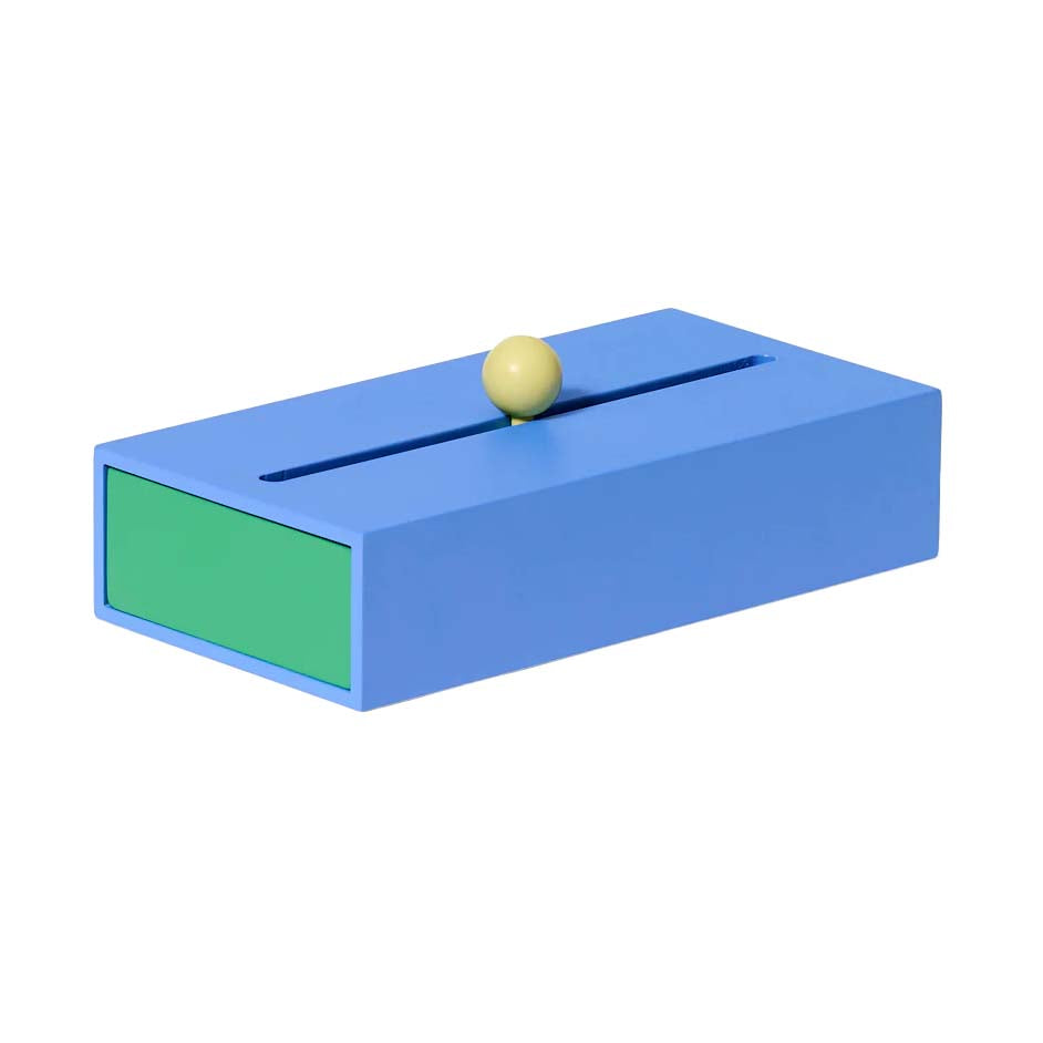 A large blue and green geometric storage box with a slot on top and a knob on the front drawer, set against a white background.