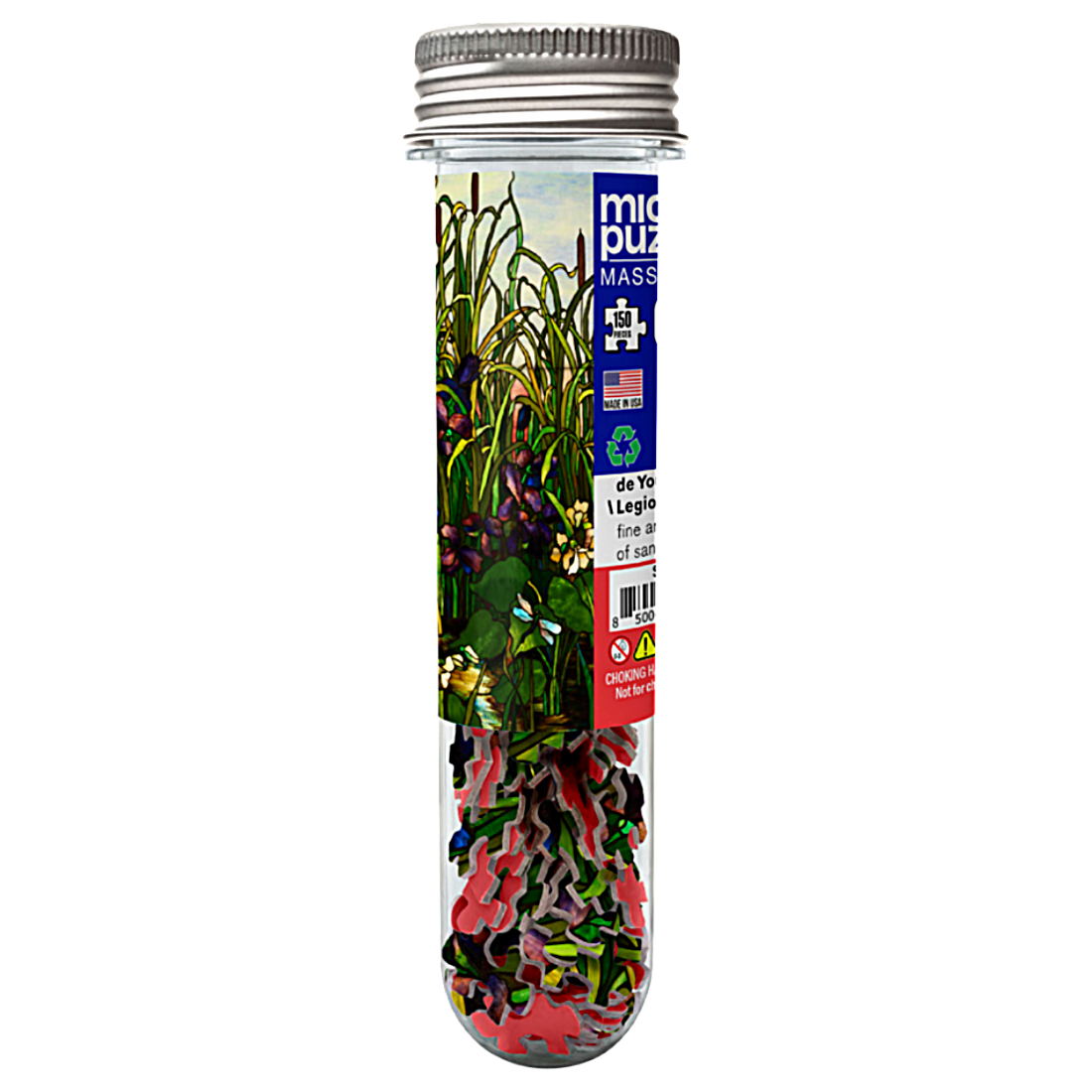 A clear glass test tube with a silver metal screw cap, filled with a colorful jigsaw puzzle featuring green leaves, red and pink flowers, and a blue label on a white background.