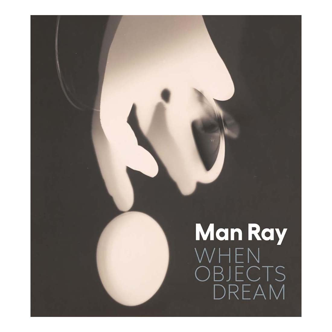 Surreal image of a hand and sphere with 'Man Ray' and 'When Objects Dream' text.