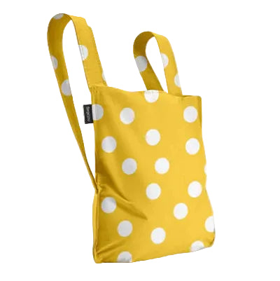 Yellow bag with white polka dots on a light gray background