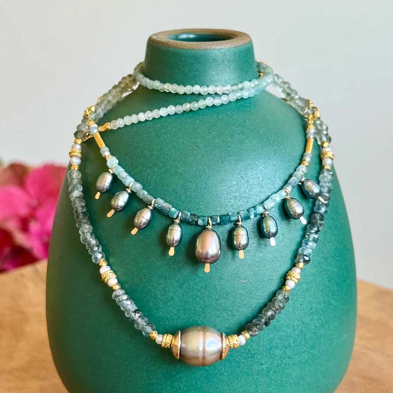 Necklace with pearls and gold chain on a white background