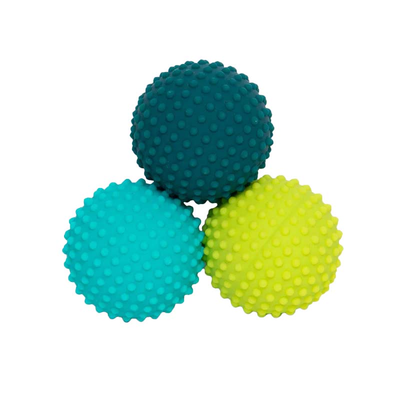 Three textured massage balls in teal, blue, and green on a white background