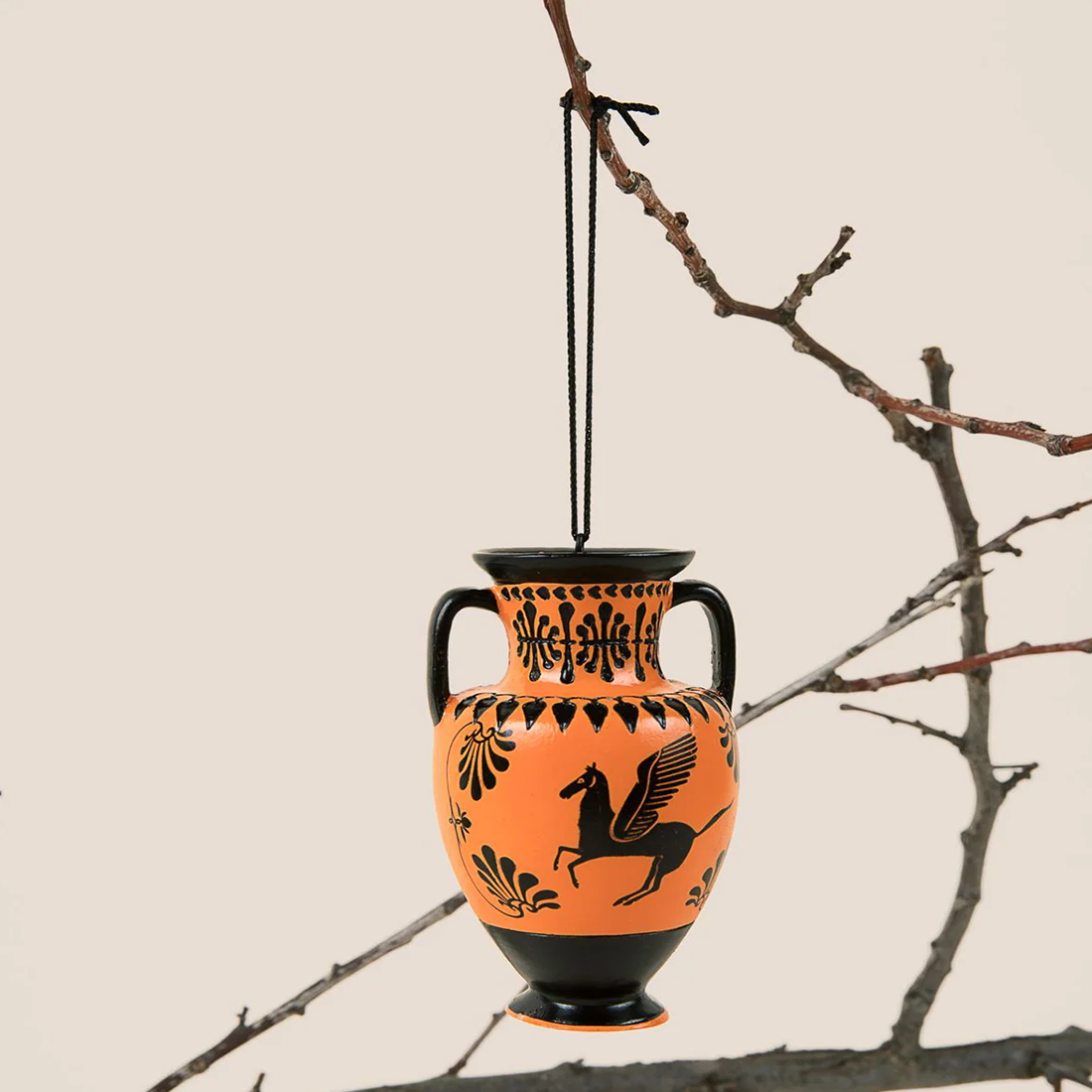Decorative vase with black and orange design on a white background