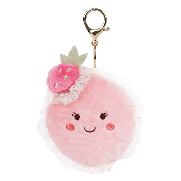 Pink plush keychain with a smiling face and strawberry on a white background