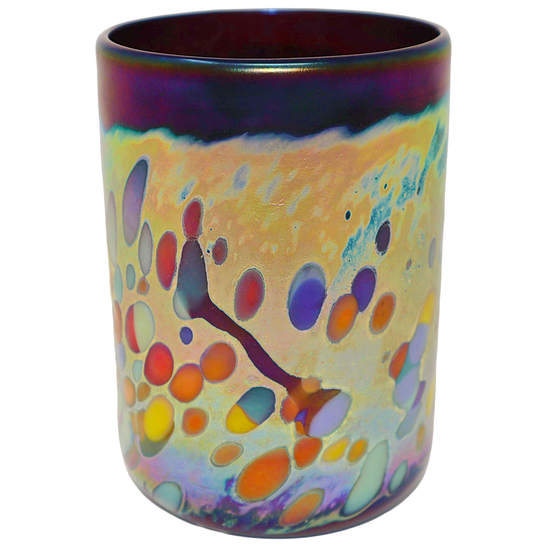 An iridescent glass cup with a colorful abstract pattern of orange, purple, yellow, and blue bubbles on a cream background, featuring a dark purple rim.
